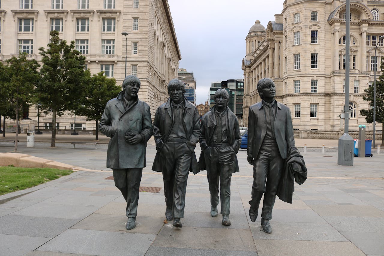 Bronze statues of a famous band in Liverpool, a notable tourist attraction.